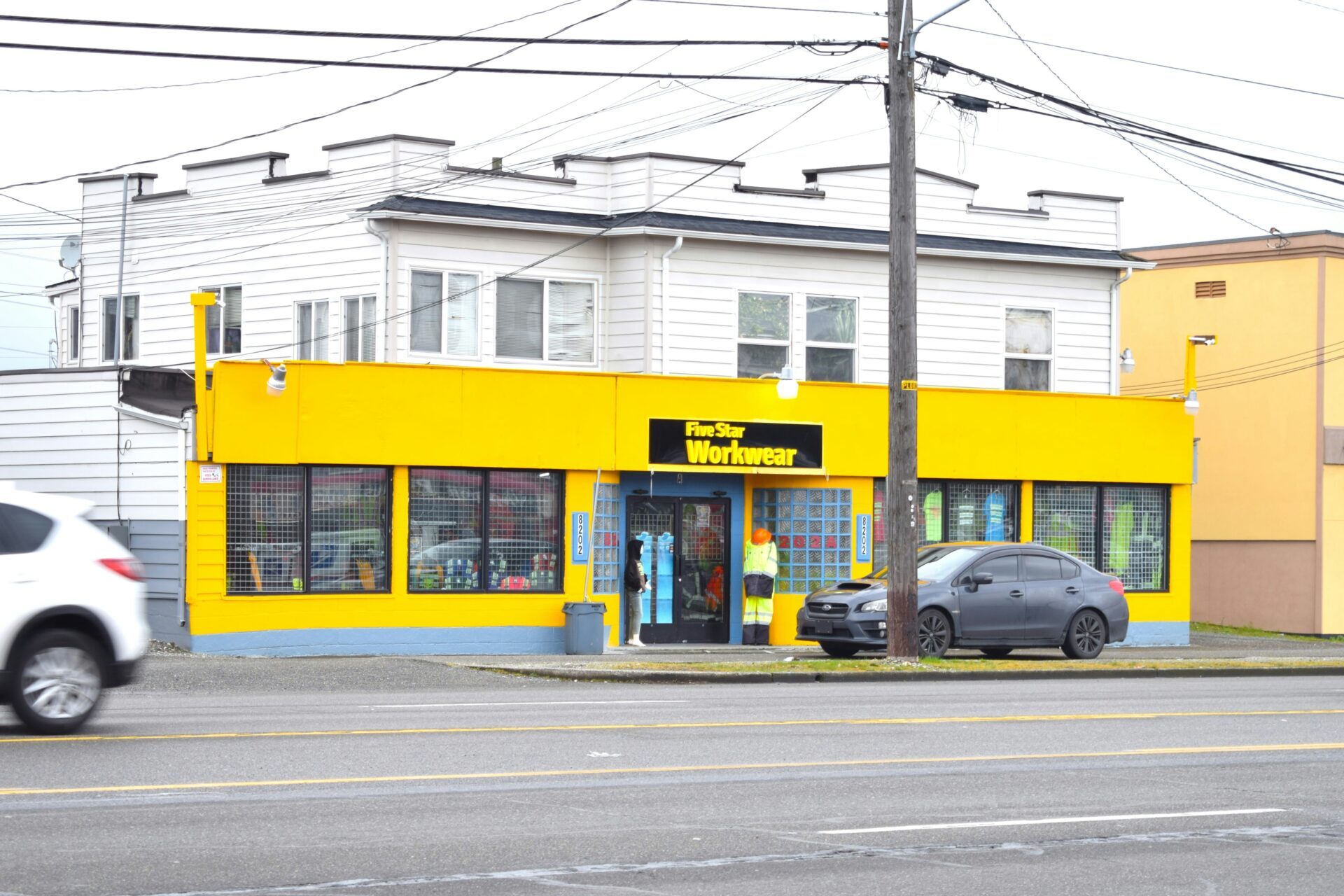 white building with a yellow storefront