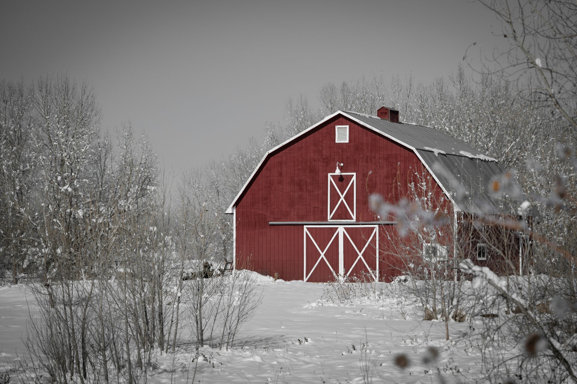 Snowy day with a large red barn