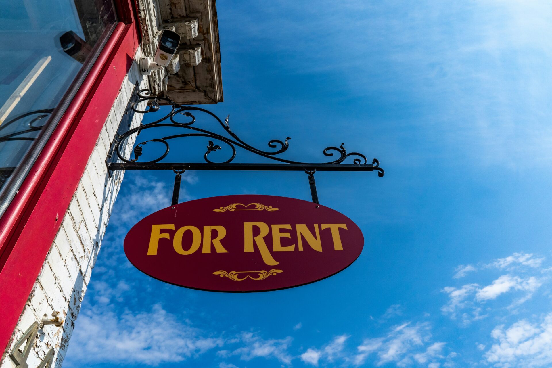 Sign hanging from building that says For Rent"